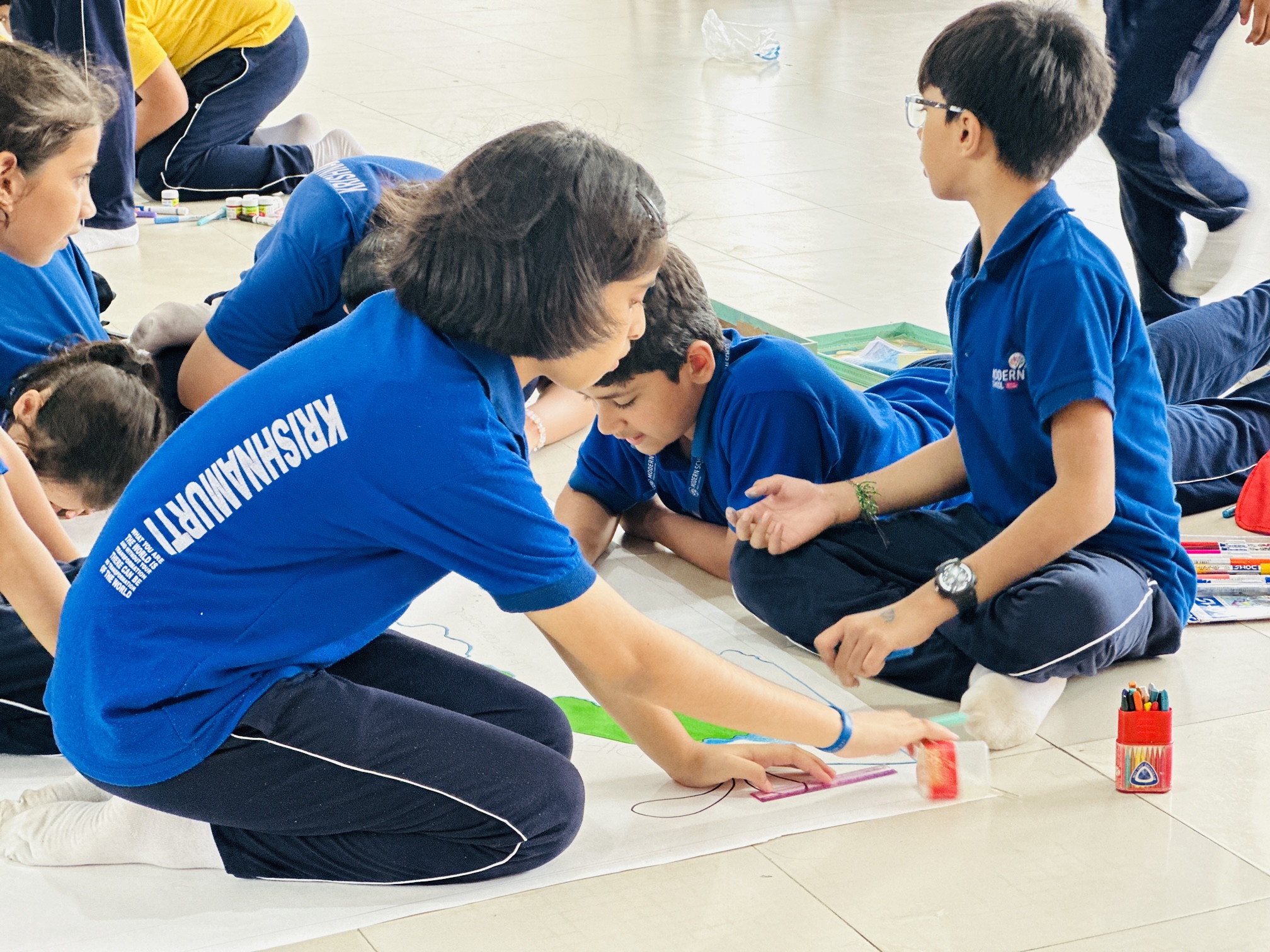 Krishnamurti House students preparing their canvas on the given theme during the Inter-House Art Competition