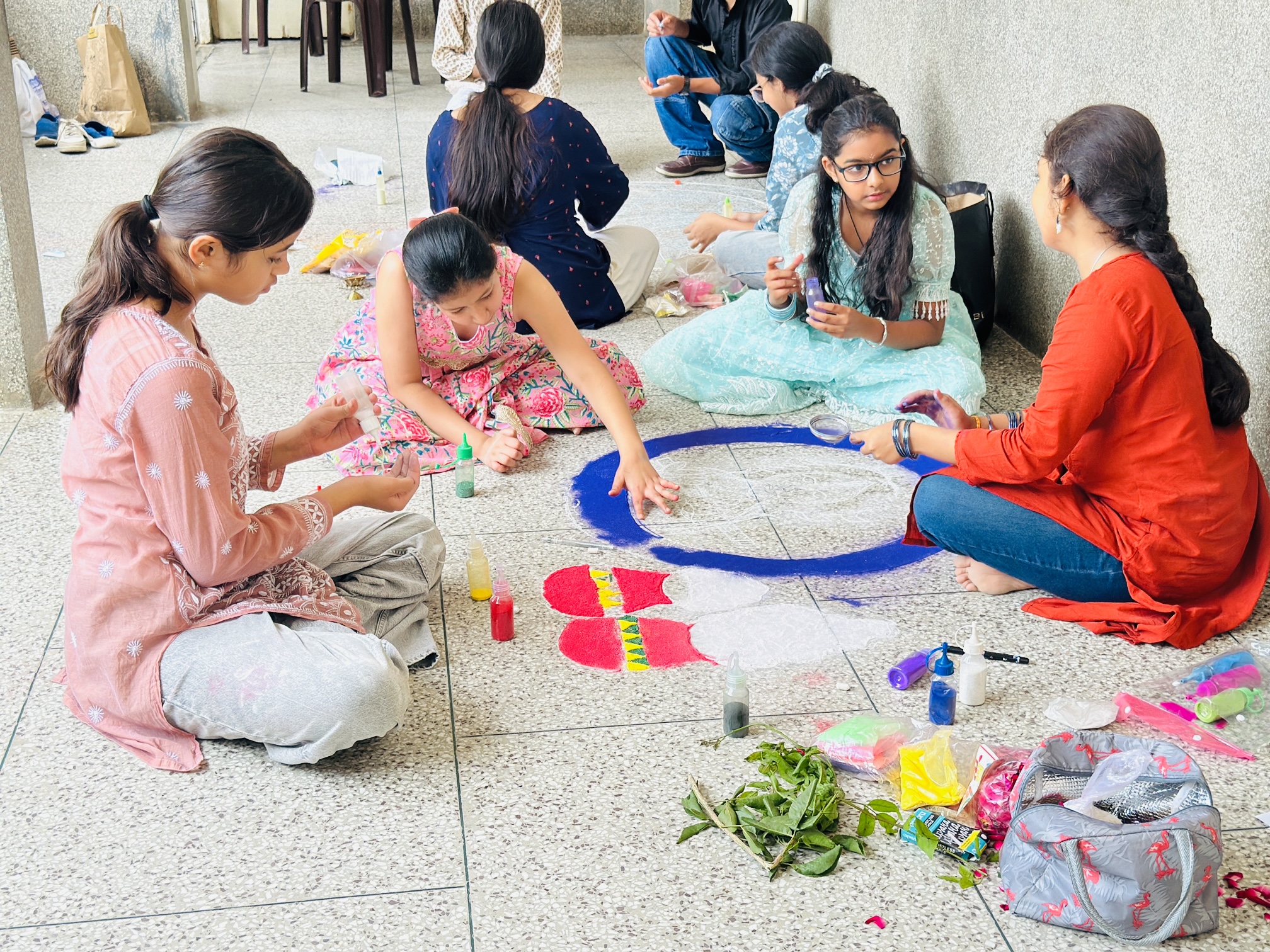 Middle school students preparing a rangoli during the Inter-House Rangoli Competition