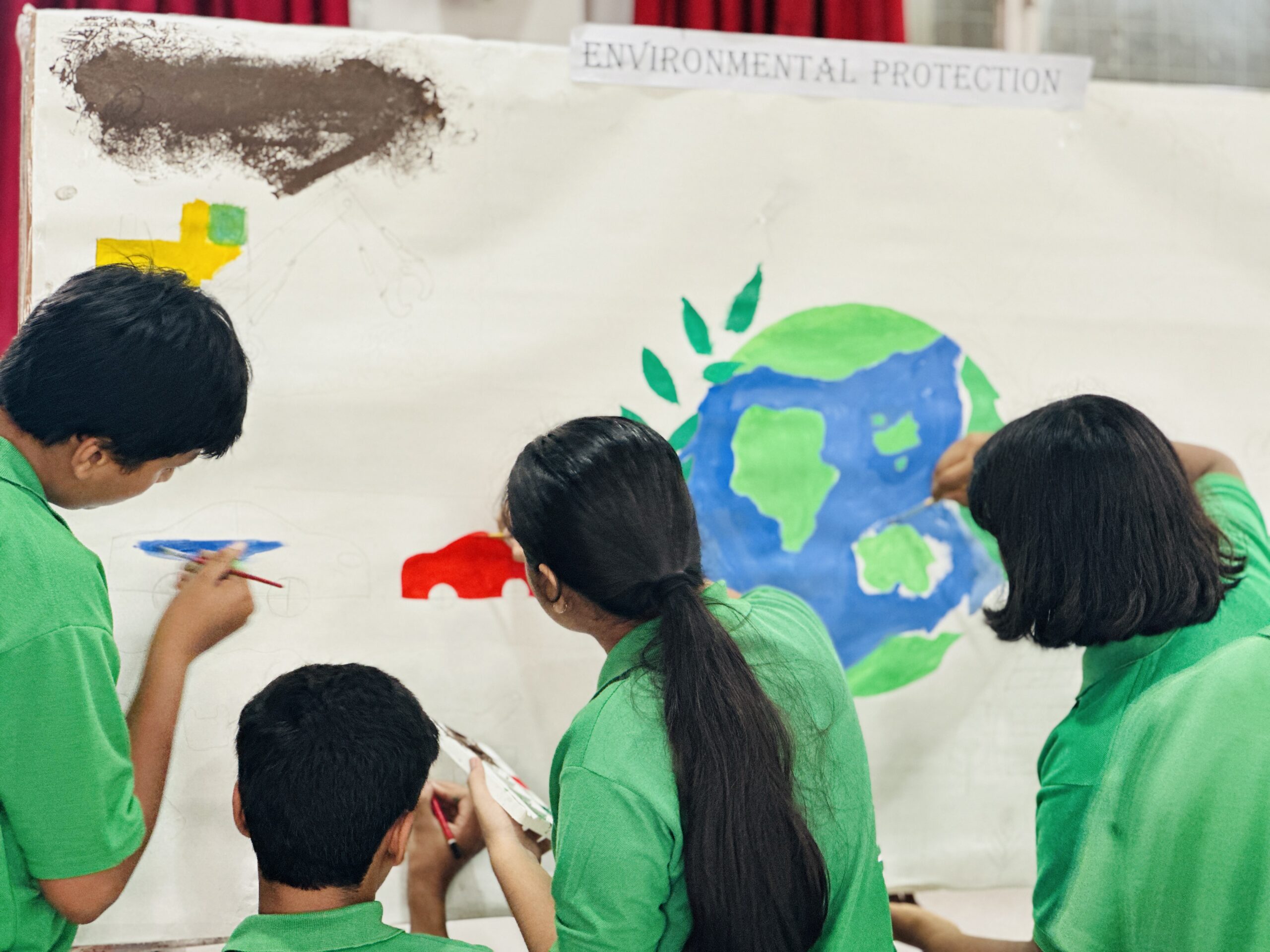 Socrates House students working on their group canvas during the Inter-House Art Competition